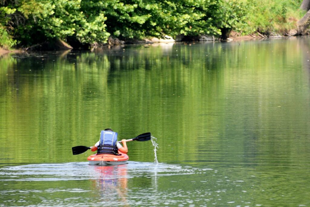 Paddling a kayak up a river in the Shenandoah Valley of Virginia
